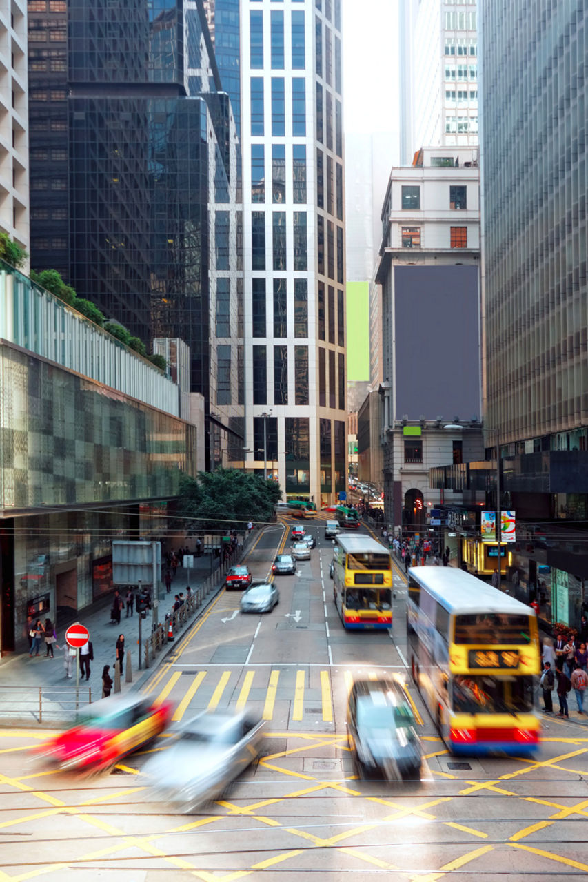Hong Kong business district with vehicles zooming